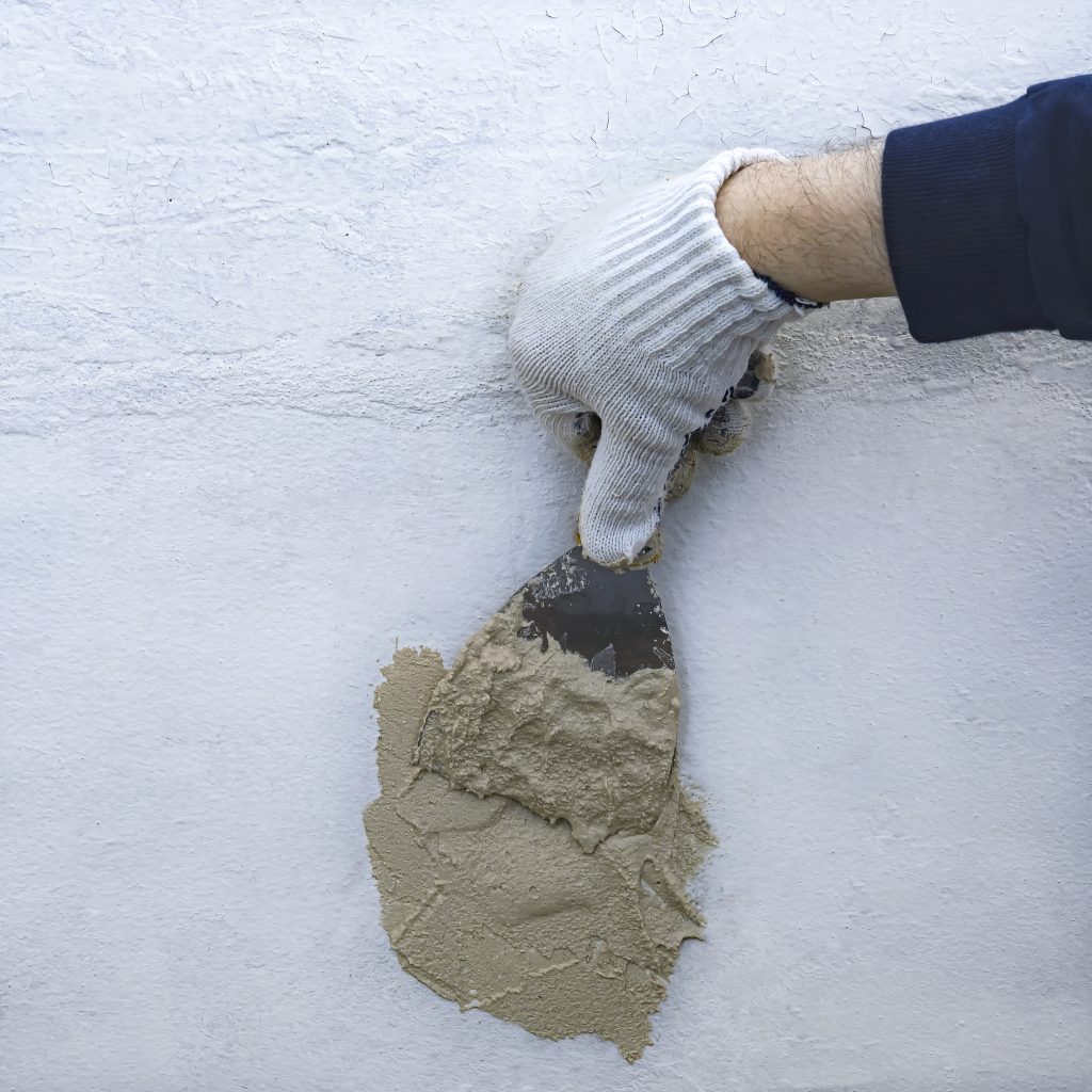 repair-work-wall-man-s-hand-with-tool-plaster-cement