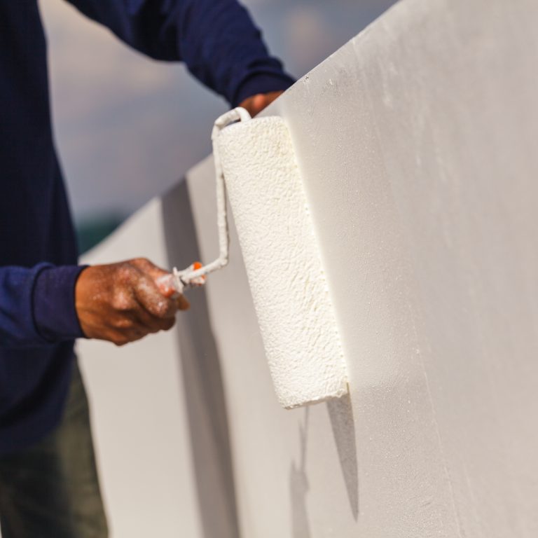 Painter man at work with a paint roller