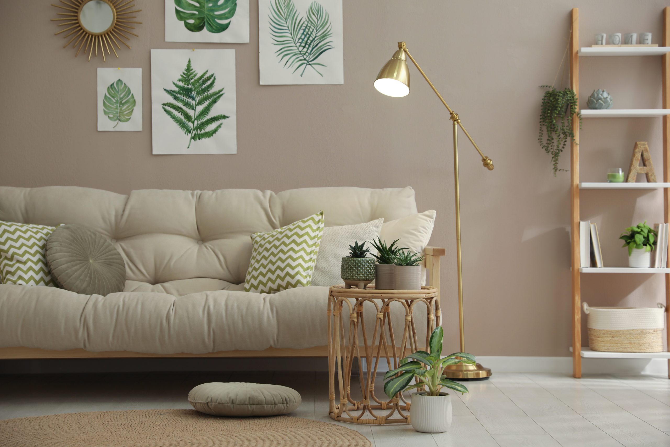 Stylish living room interior with comfortable sofa and beautiful pictures on wall